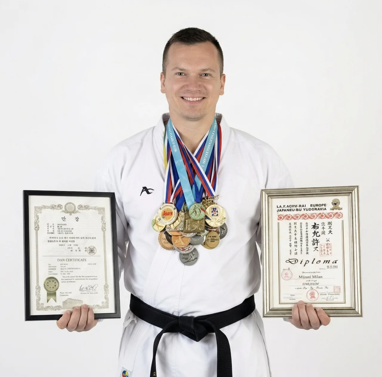 Coach Milan with championship medals and master diplomas